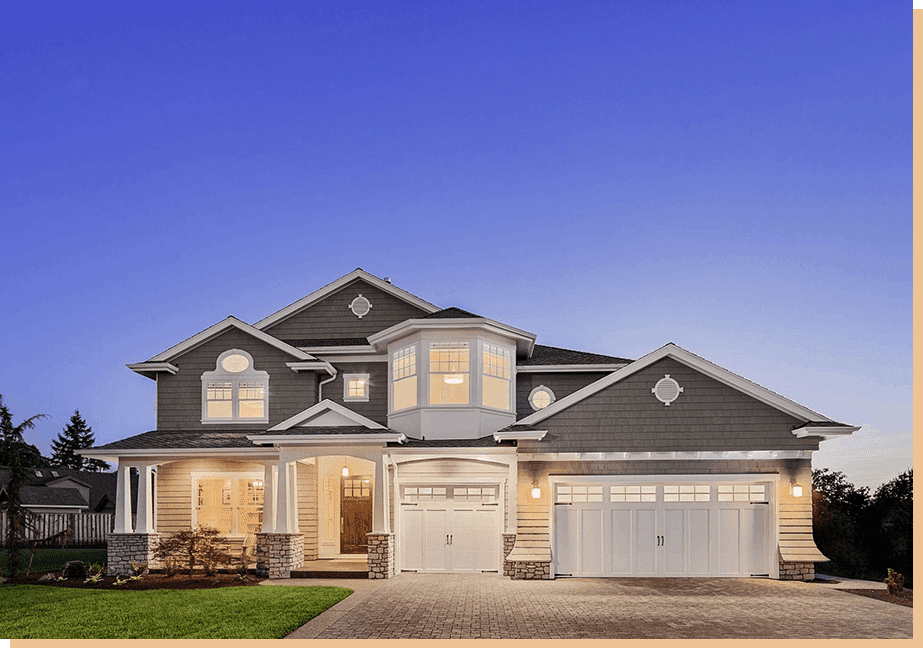 A large house with two garage doors and a driveway.