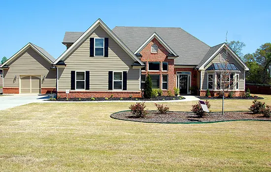 A large house with a lawn in front of it.